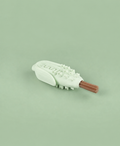 Pale green corn-shaped chew enrichment toy holding a slim treat
