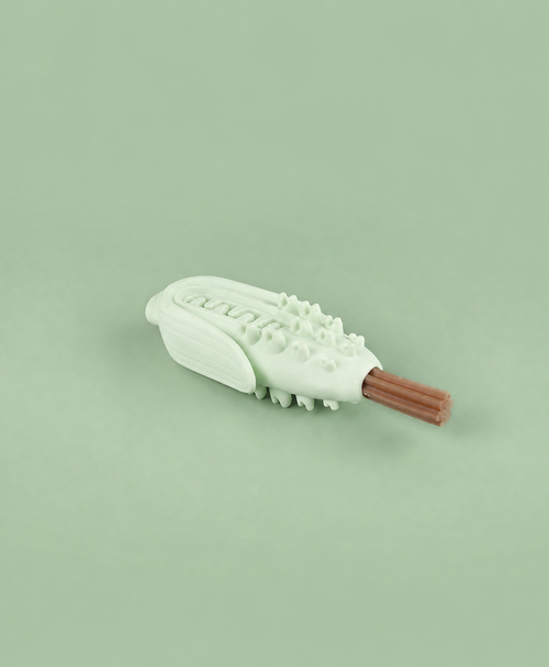 Pale green corn-shaped chew enrichment toy holding a slim treat